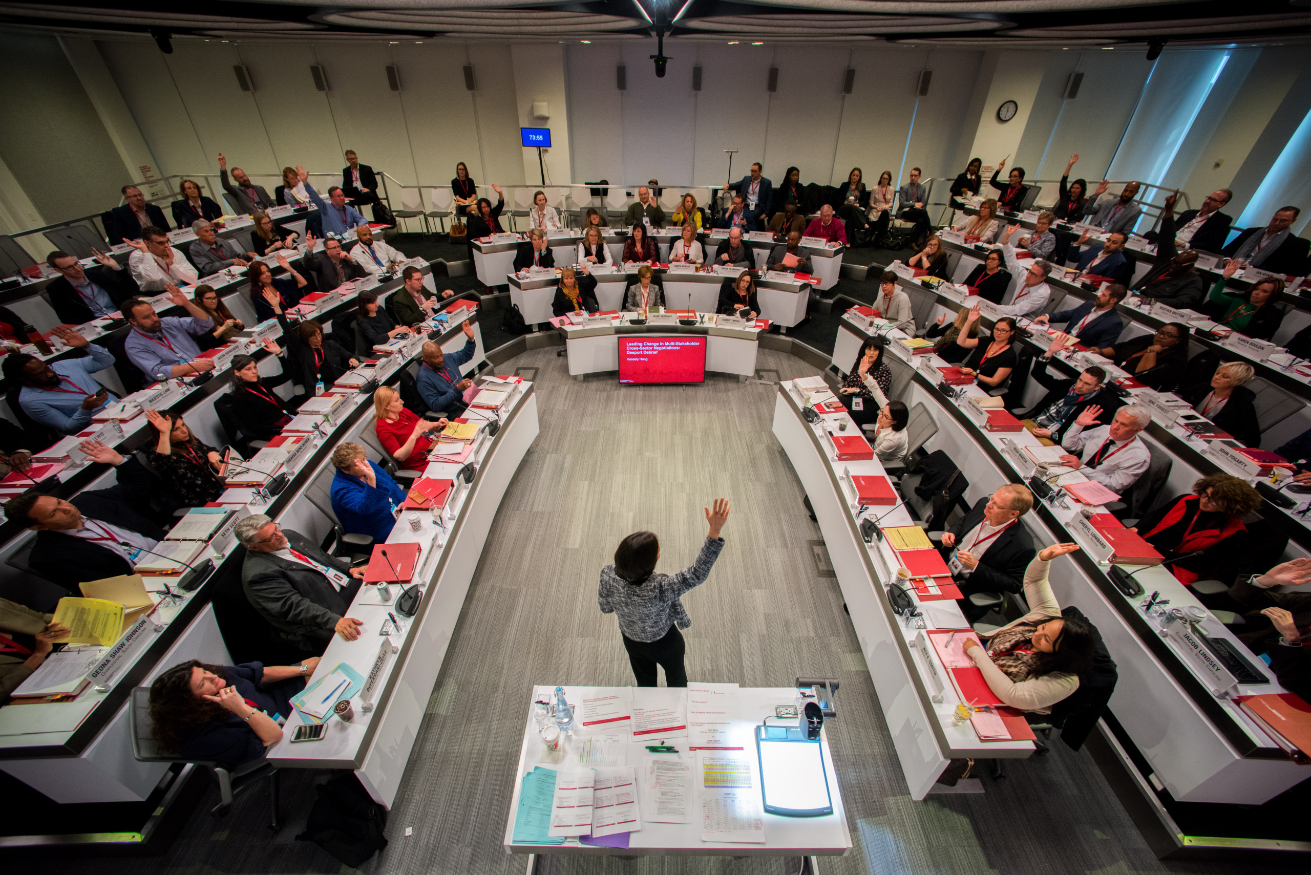 Mayors seated together listen to a presentation as part of the Bloomberg Harvard City Leadership Initiative