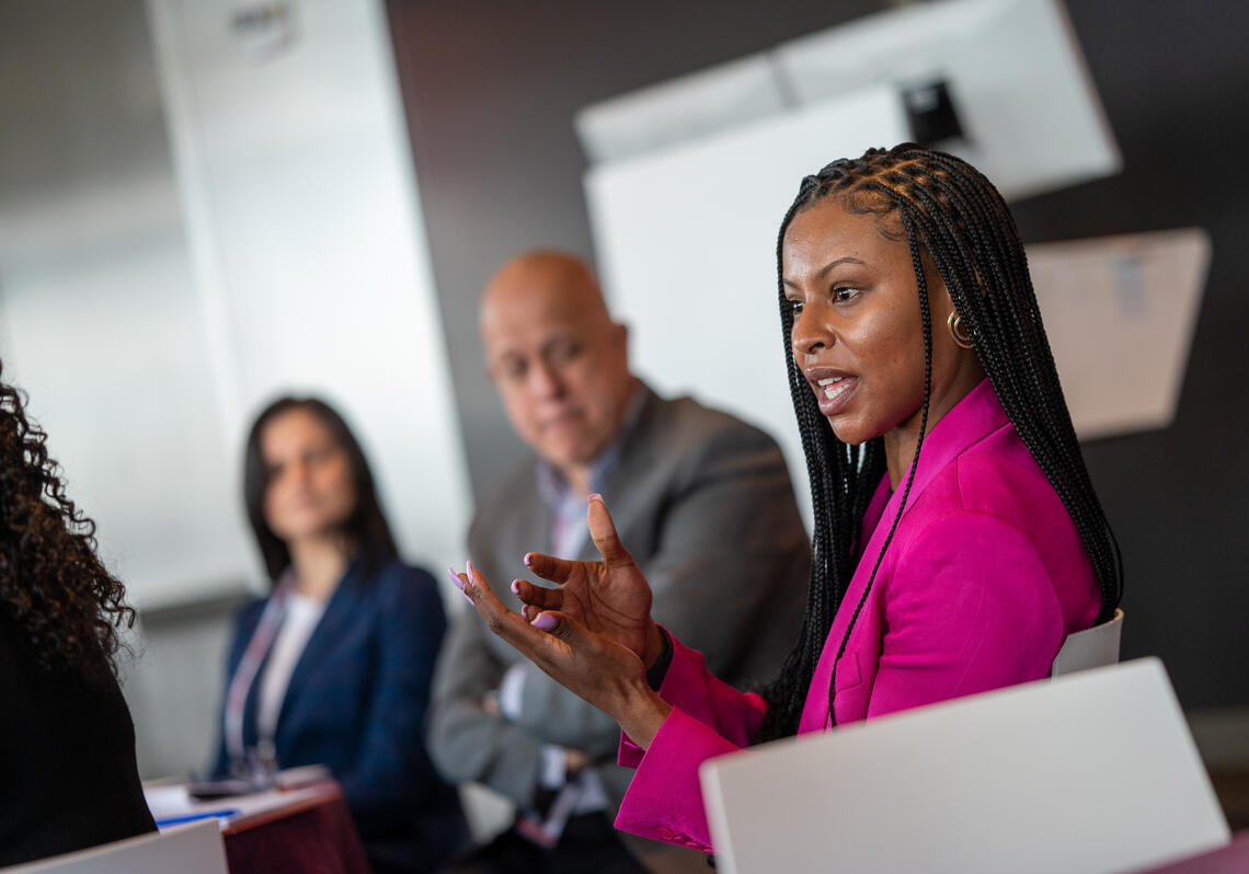 Three city officials discuss their work in a professional setting.