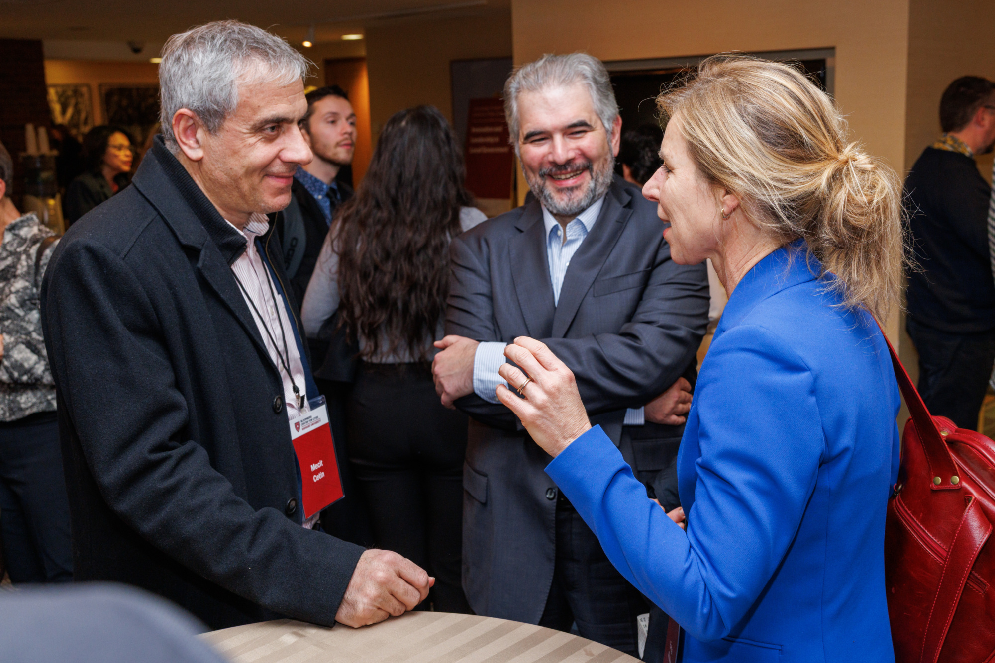 Three researchers in an animated discussion