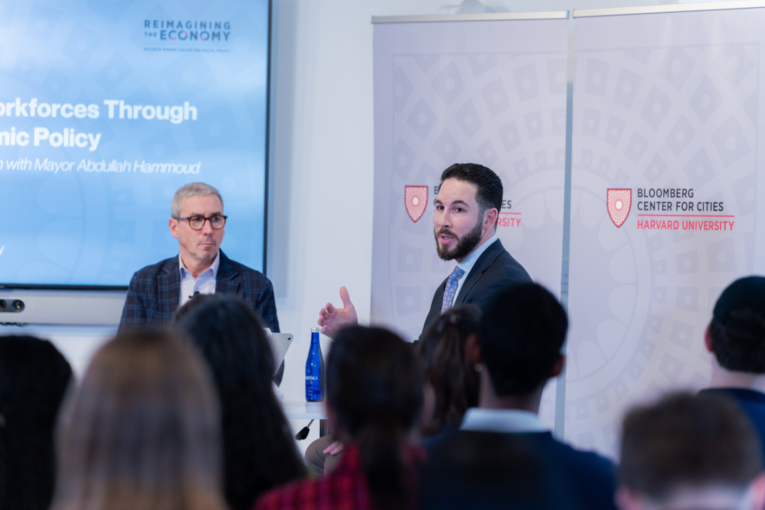 Speakers seated in front of audience