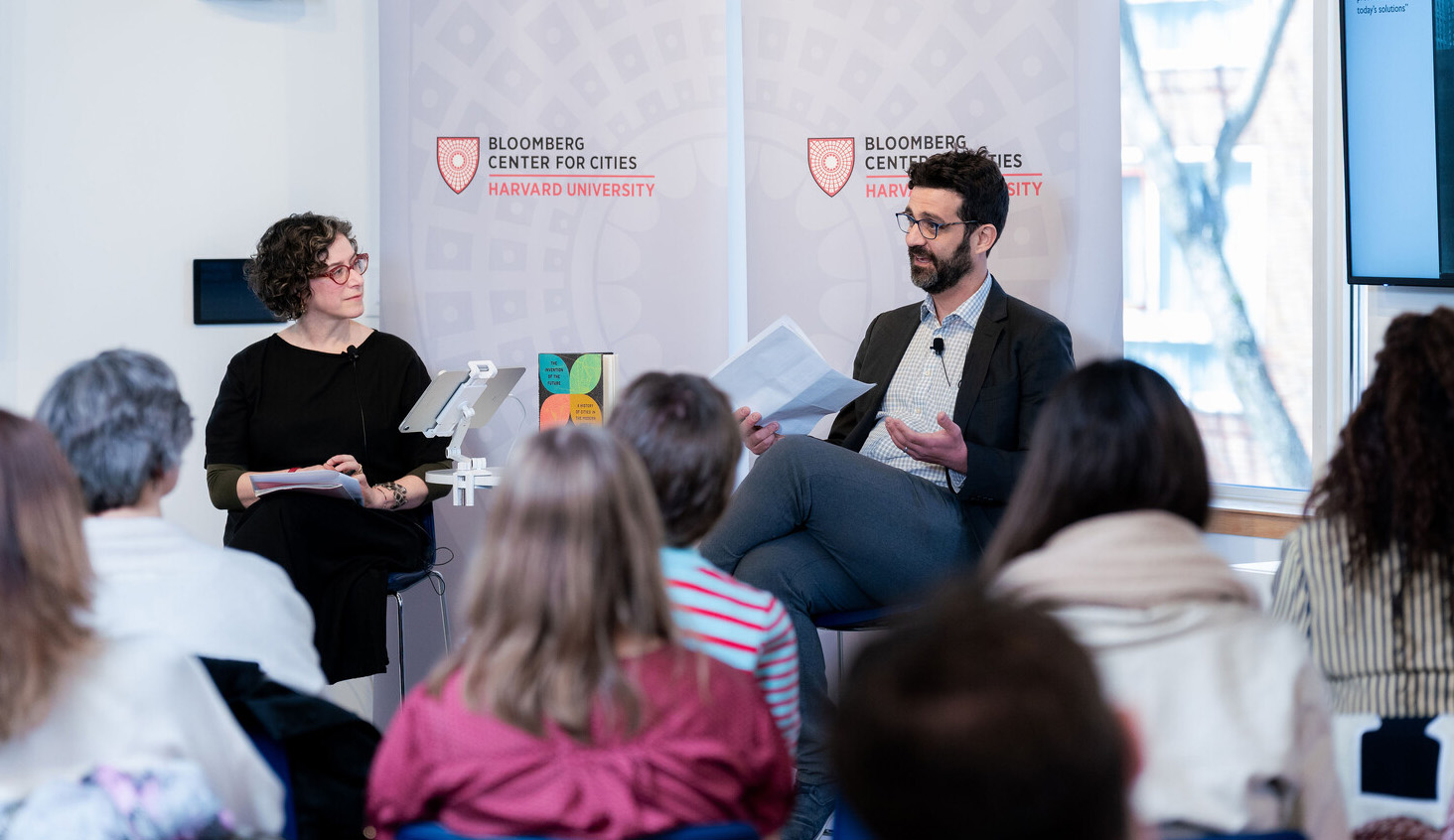 Speakers seated before audience at the Bloomberg Center for Cities